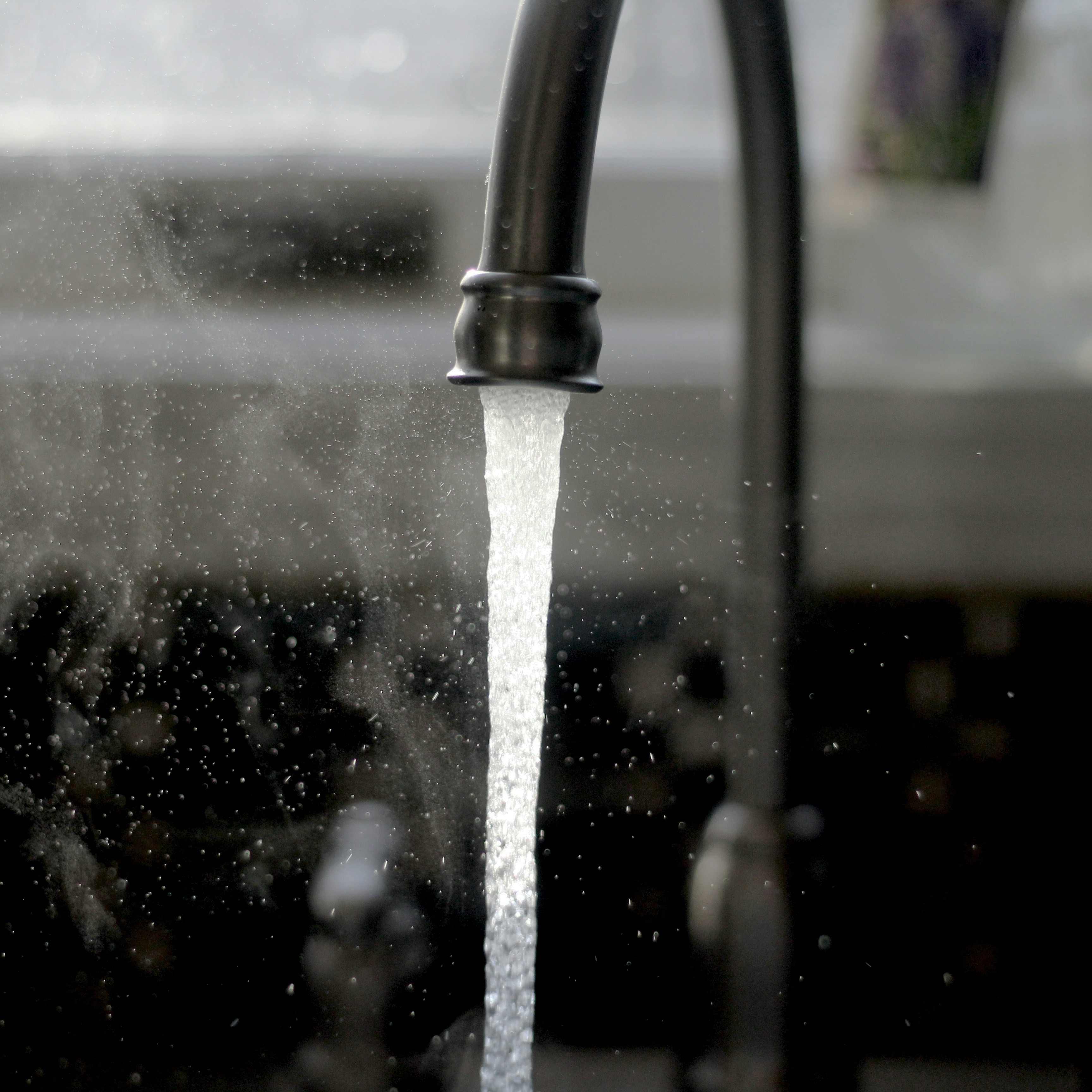 Close-up photograph of a tap with water running out of it