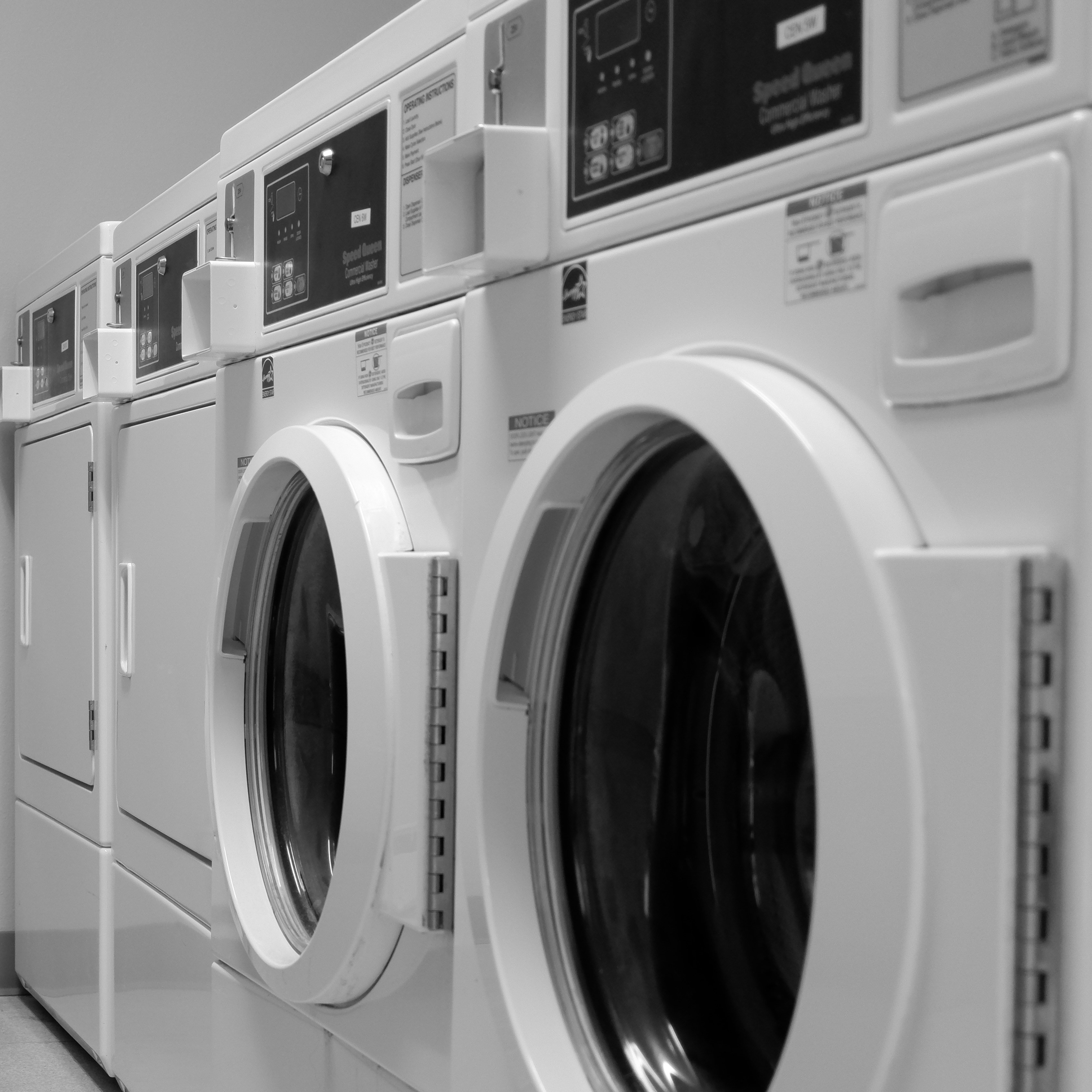 Photograph of two washing machines side by side in a laundry room